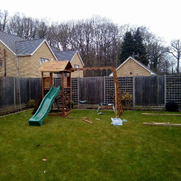 New Assembled Climbing frame with swing and slide set in a garden
