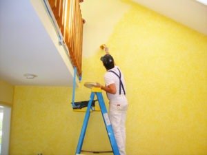 Handyman painter on a ladder