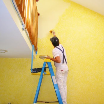 Handyman painter on a ladder