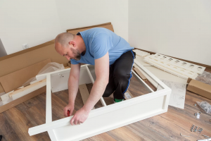 Picture of a guy assembling furniture