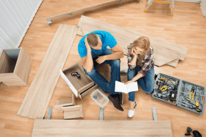 Picture of a couple looking at the furniture assembly instruction manual