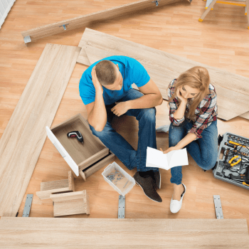 Picture of a couple looking at the furniture assembly instruction manual