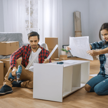 Picture of a couple trying to assemble ikea furniture