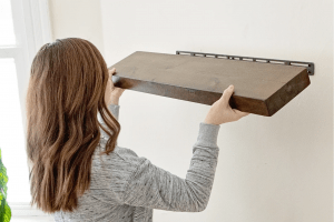 Picture of lady installing a shelf
